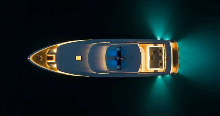 Birdseye view of Alia Yachts Virgin Del Mar at night with hull lights on