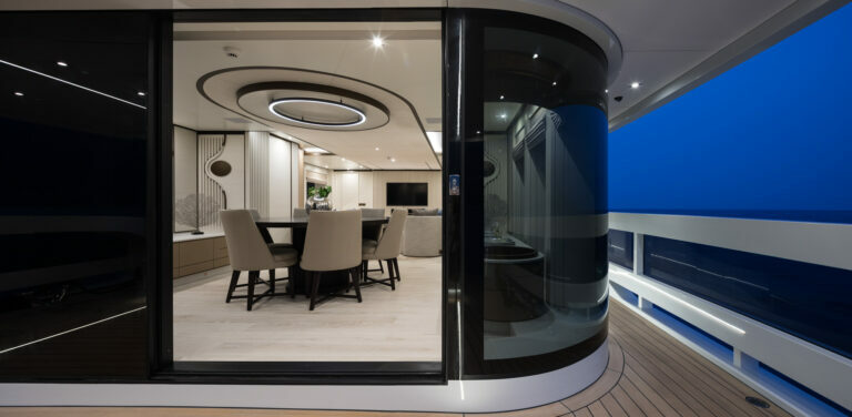 Alia Yachts Virgin Del Mar main deck at night looking into the dining area