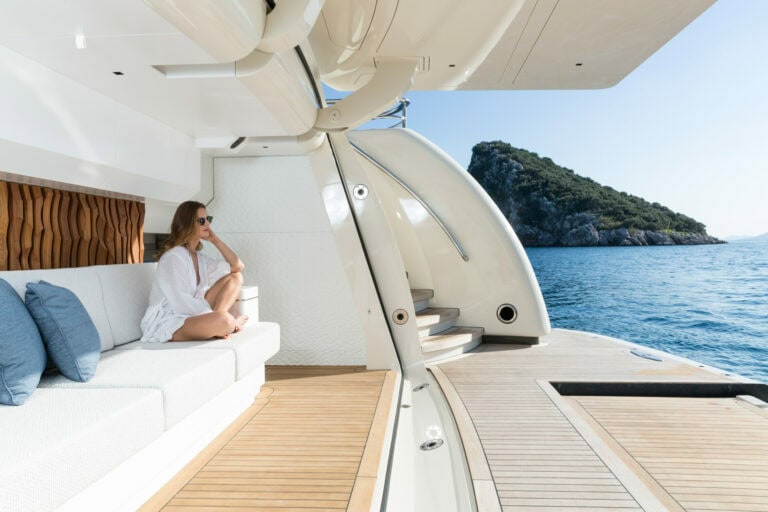 lady sitting on the swim deck of the Alia Yachts RÜYA looking out to sea