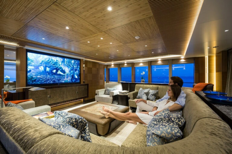 Couple watching TV in the lounge of the Alia Yachts RÜYA