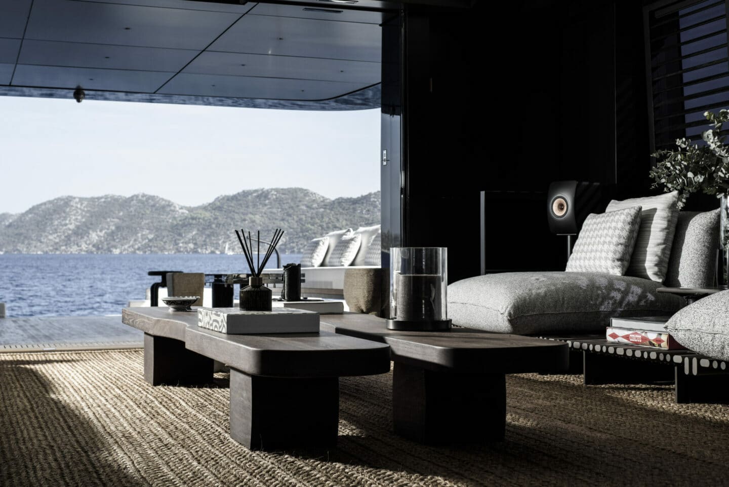 Superyacht lounge with sofa, dinning table and expensive decor with view out to sea